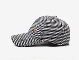 Vue latérale d'une casquette pied-de-poule avec détail lettre M en métal doré