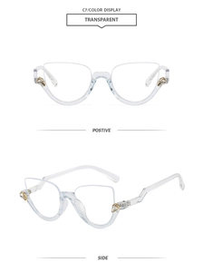 Detail view of transparent cat eye glasses with gold drop accents and crystal inlay
