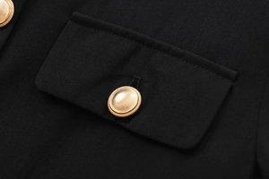 Detailed view of luxury black fabric texture and premium golden metal button detailing