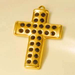 Detailed view of a gold-plated stainless steel cross pendant set with black rhinestones