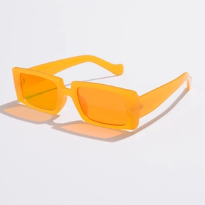 Detail shot of vintage bright orange square sunglasses with semi-transparent lenses