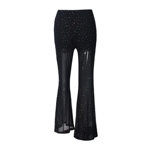 Detail of sheer black mesh flare pants with sparkling colorful rhinestones and sequins