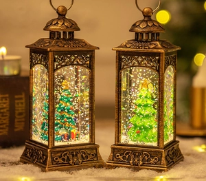 Detail of vintage bronze Christmas lantern with LED snow scene and festive green tree