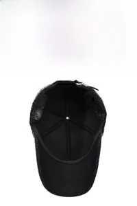 Detail of winter baseball cap with thick black faux fur lining and ear protection flap