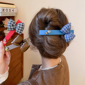 Detail of Korean-style bow hair clips with rhinestones and floral accents in multiple colors