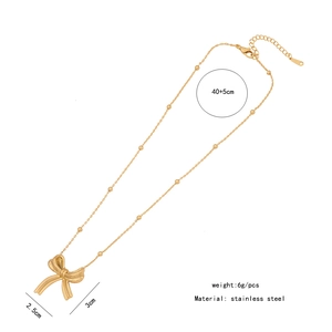 Detail showing dimensions of golden bow pendant and stainless steel chain necklace
