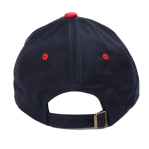 Detail of navy baseball cap back showing red top button and adjustable brass buckle strap
