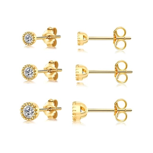 Macro shot of three gold sterling silver stud earrings with round cubic zirconia and milgrain edge