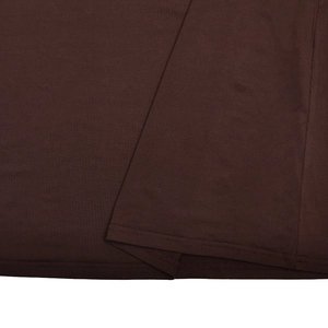 Detailed close-up of brown dress fabric showing intricate stitching and woven texture