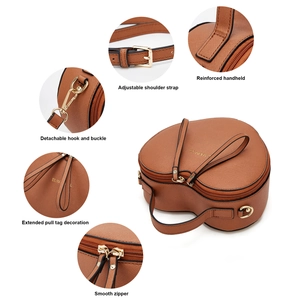 Detail view of brown heart bag showing reinforced handle and adjustable metal buckles