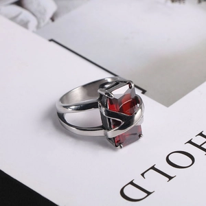 Macro detail of silver stainless steel ring featuring a large rectangular red ruby stone