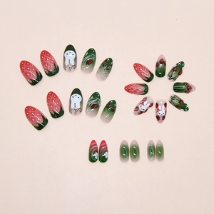 Detail of press-on nails with 3D strawberry, rabbit motifs and soft gradient finish