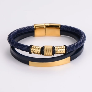 Detail of dark blue multilayer braided leather bracelet with golden magnetic buckle