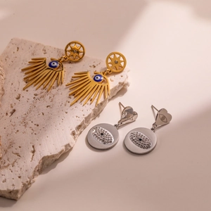 Irregular geometric evil eye drop earrings in gold and silver with rhinestones