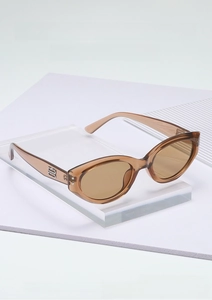 Detail of amber cat-eye sunglasses featuring silver metal logo on the temple