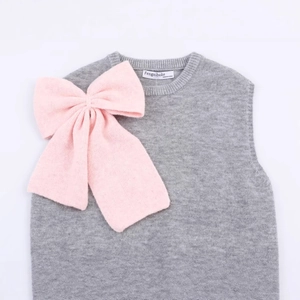 Gray knitted vest top featuring a large pink bow decoration and round neckline