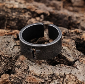 Close-up of retro hollow cross pattern on matte stainless steel biker style ring