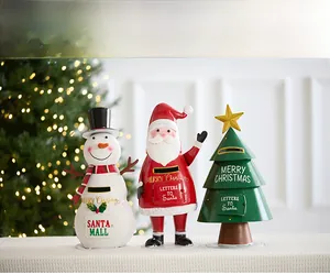Close-up of three festive metal mailboxes with Santa Mail and Snowman designs