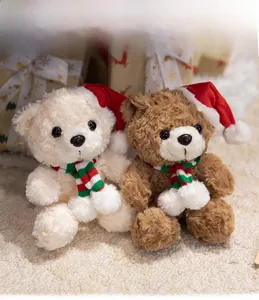 Close-up of plush Christmas teddy bears with red Santa hats and striped knit scarves