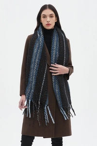 Detail of a thick striped wool scarf with orange and blue patterns and fringe tassels