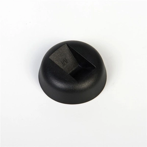 Macro shot of the black round base stand with a molded letter M for jewelry display