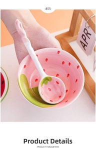 Close-up of hand holding a cute strawberry ceramic bowl and matching spoon with glossy finish