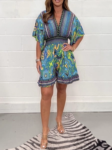 Detail of bohemian floral print V-neck jumpsuit with ruffled sleeves and elastic waist