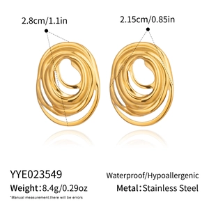 Detailed macro view of gold-layered geometric stainless steel earrings with textured finish