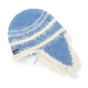 Detail of blue and white plush knit beanie with soft faux fur texture and side logo