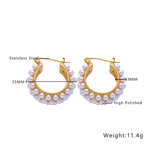 Detail view of 25mm polished gold stainless steel hoop earrings with baroque pearl