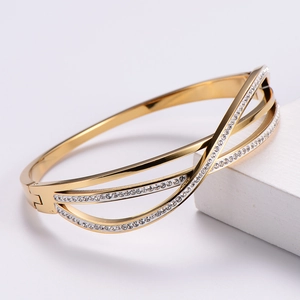 Elegant gold-plated criss-cross open bangle with shimmering pavé rhinestones for women