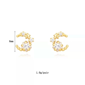 Detail view of gold star and crescent moon stud earrings with 6mm size and 1.0g weight