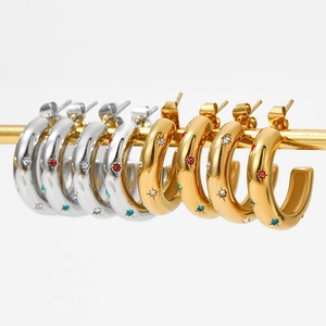 Polished C-shaped hoop earrings with colorful zircon star insets in gold and silver