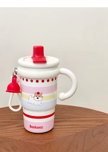Close-up of a sturdy handle on a pink striped ceramic mug with cute dog illustration