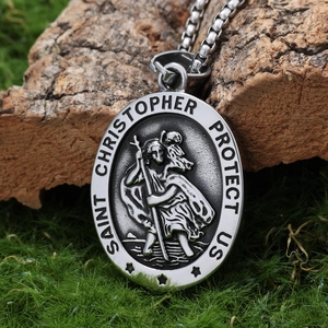 Detailed close-up of Saint Christopher oval medal on natural moss and tree bark background