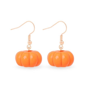 Detailed view of orange pumpkin earrings with gold hooks on a clean white background