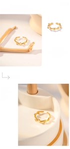Detail of vintage irregular gold wave ring featuring embedded white mini pearls