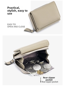 Detail of the high-capacity rear zipper pocket on a gray pebbled leather tri-fold wallet