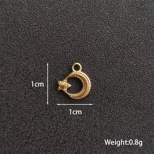 Macro shot of 1cm golden star moon pendant for DIY jewelry making with weight details