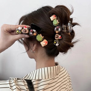 Cute cartoon bear and chocolate donut hair claw clip shown in a Korean style hair updo