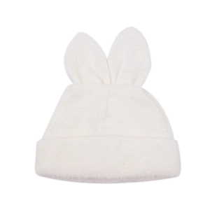 Close-up of white knit beanie featuring soft rabbit ears and fluffy plush texture