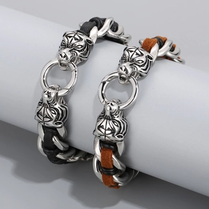 Detailed view of bold tiger head bracelet with metal chain and braided leather cord