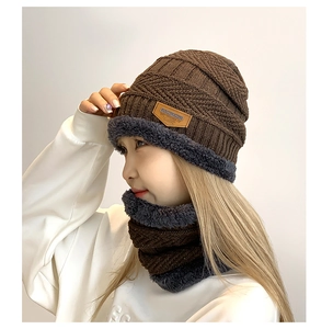 Detail view of winter knitted beanie hat and neck warmer with warm grey fleece lining