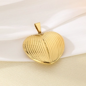 Detail of 18K gold plated heart pendant with ribbed texture on elegant silk background