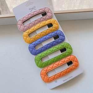 Detail of 5-piece PU leather hair clip set with diamond texture in vibrant pastel colors
