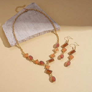Vintage gold necklace and earrings set with orange and brownish geometric resin gems