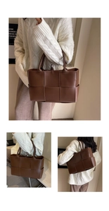 Close-up of the woven texture and spacious structure of this brown faux leather tote bag