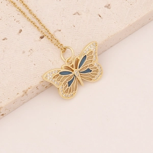 Golden butterfly necklace with blue enamel and sparkling cubic zirconia on stone base