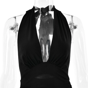 Detail of black halter neck dress with pleated chest design on transparent mannequin