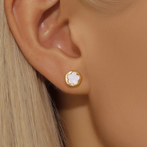 Detail of s925 silver flower stud earring with white shell inlay worn by a model